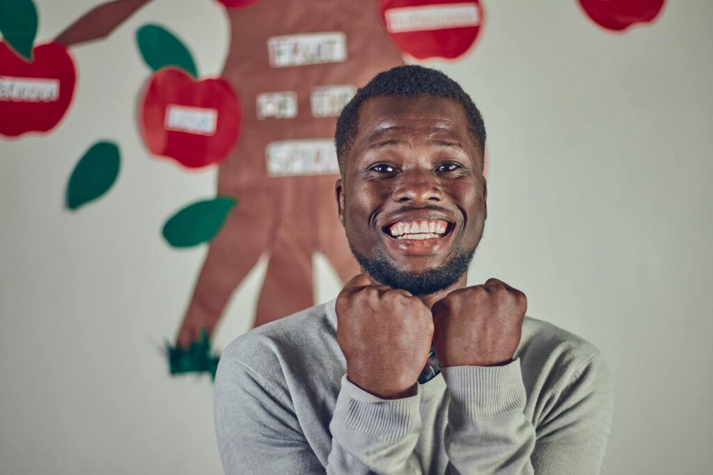 African Man in Front of Child Paintings